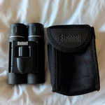 Bushnell 12X25MM Folding Binoculars, 240FT At 1000YDS, With Original Case. Fixed Price $14.99.